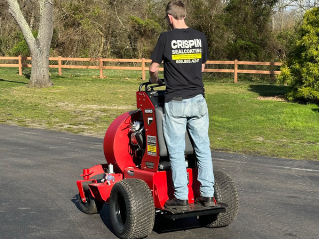 A person on a red FB3000 Hurricane™ Stand-On Blower